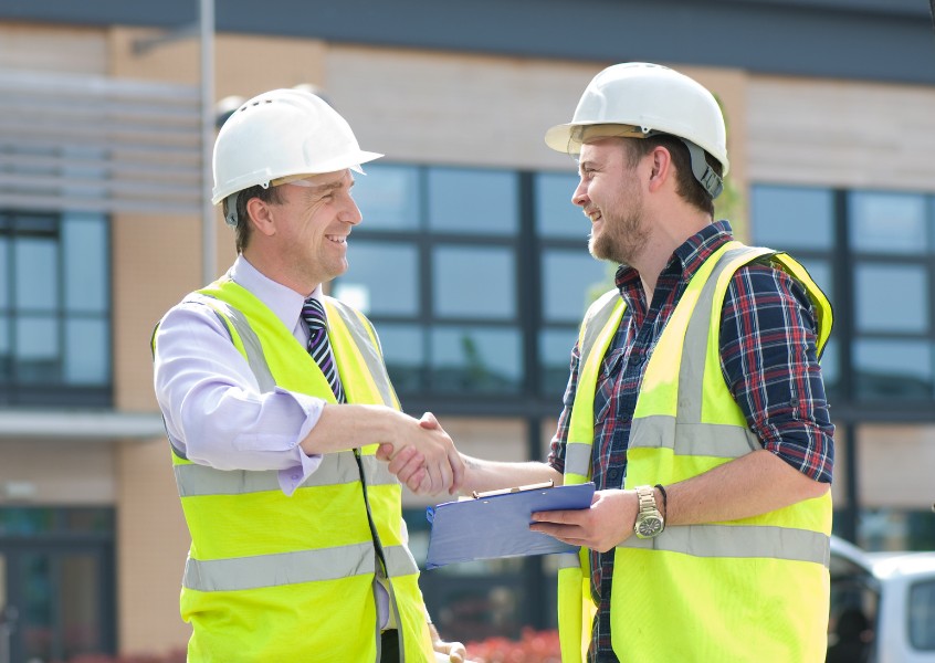 contractor and bond agent shaking hands