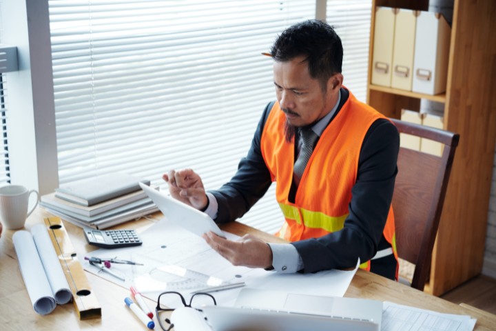 contractor checking documents in the office