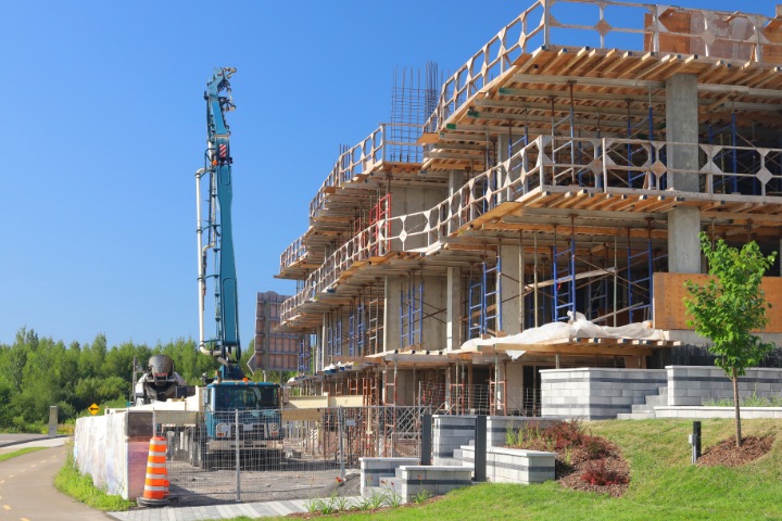 Active construction site with scaffolding and machinery