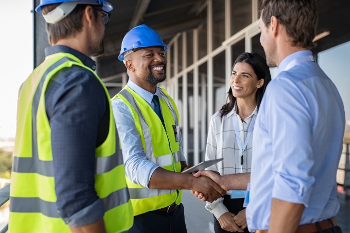 Contractor and client shaking hands, highlighting the importance of surety bonds in building a positive contractor reputation