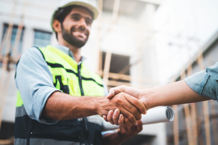 A professional handshake demonstrating a successful contractor-surety partnership