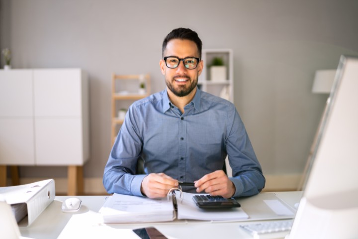 A surety advisor sitting confidently at their desk, ready to assist with bonding needs